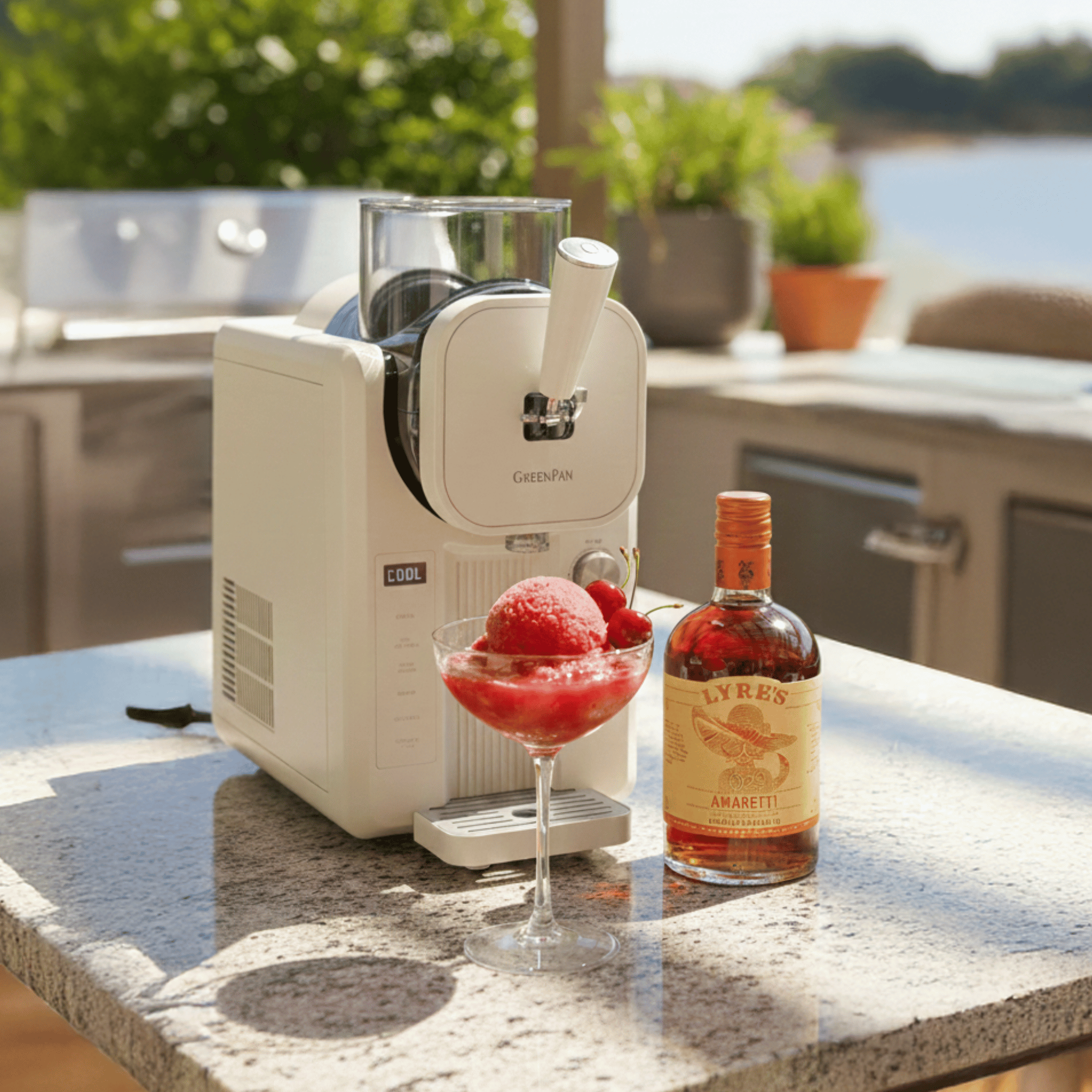 GreenPan machine with a sorbet and a bottle of Lyre's Amaretti on a table outdoors.