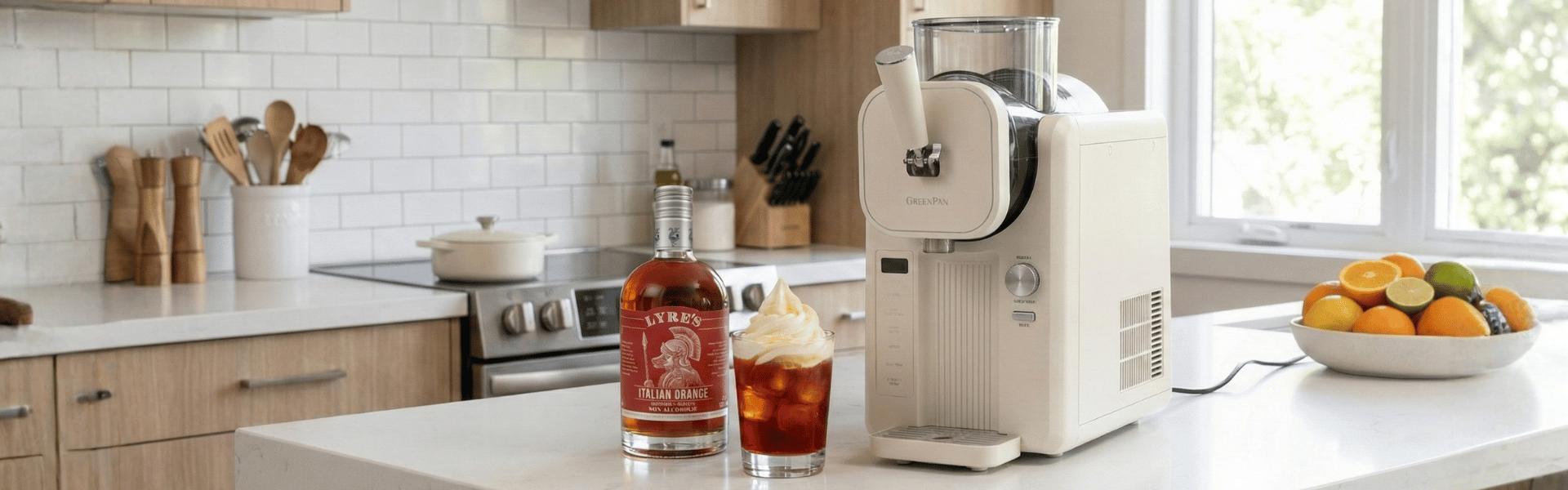 Kitchen scene with a coffee machine, bottle of Lyre's Italian Orange, GreenPan machine and fruit bowl.