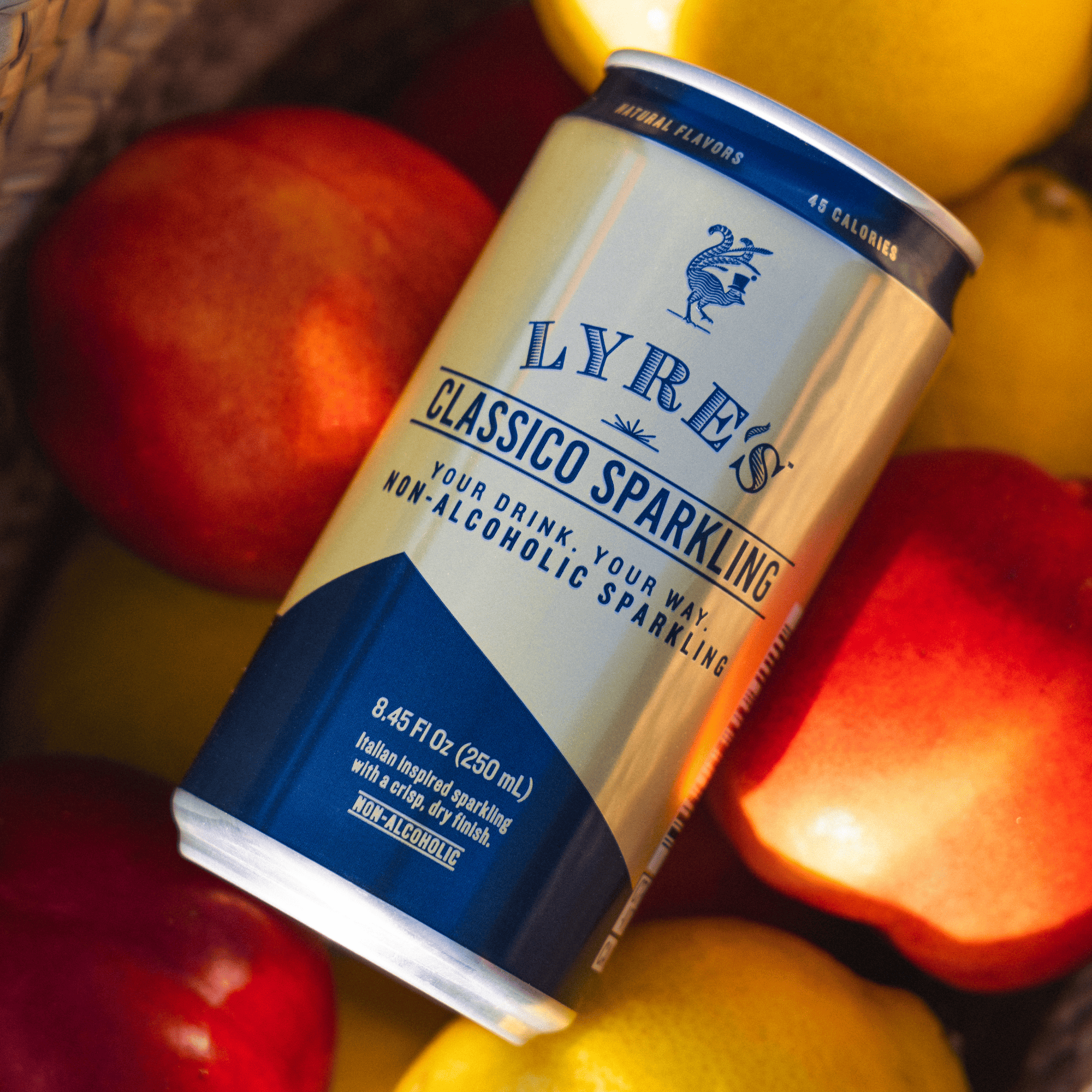 Can of Lyre's Classico Sparkling non-alcoholic sparkling drink surrounded by apples and lemons.