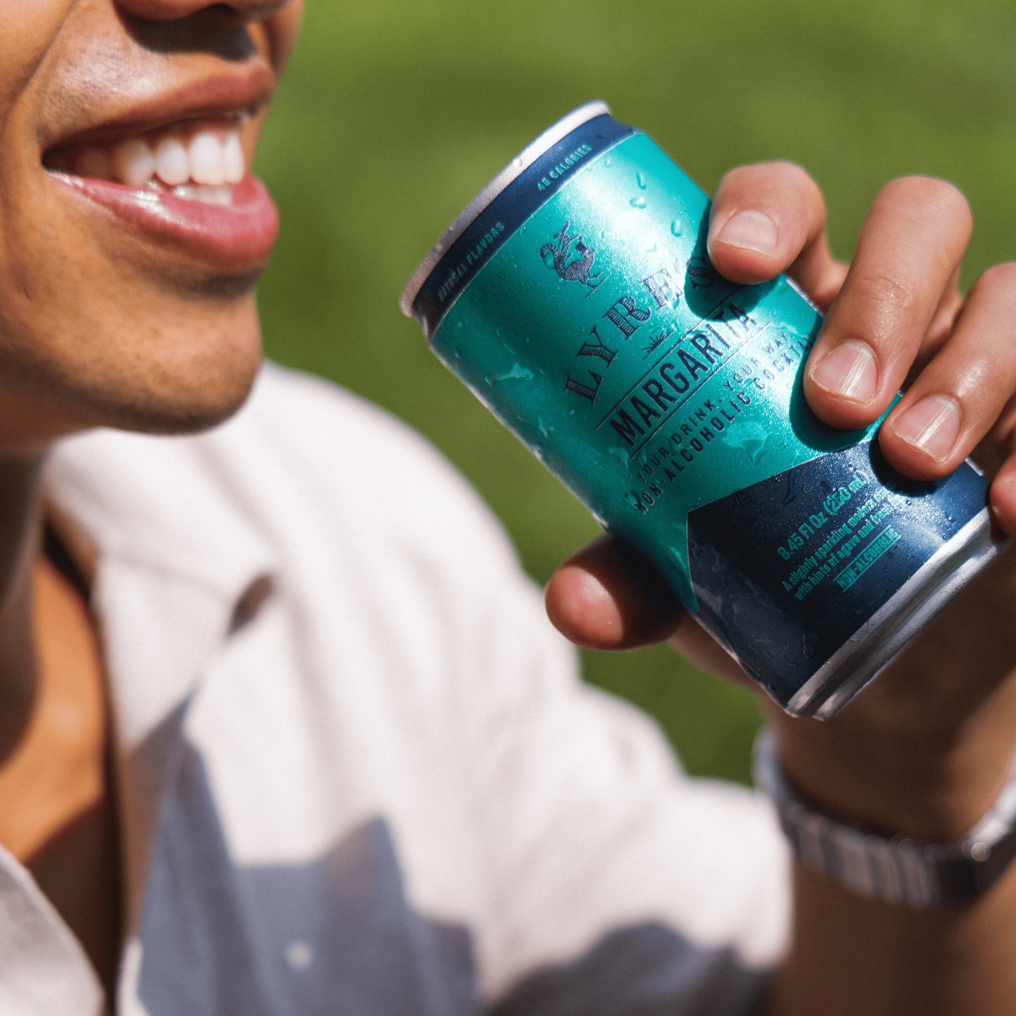 Person holding a can of Lyre's non alcoholic Margarita, outdoors