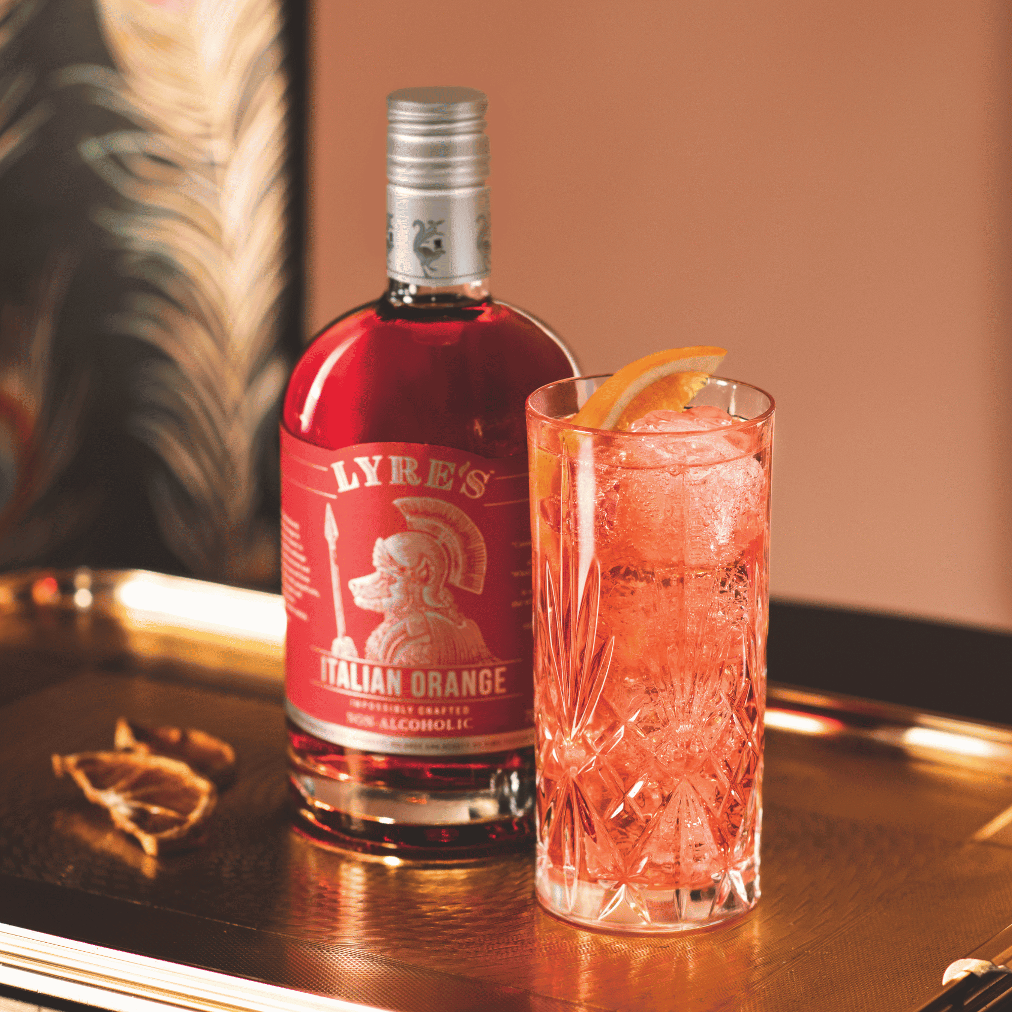 Lyre's Non Alcoholic Italian Orange bottle with a mocktail on a wooden surface