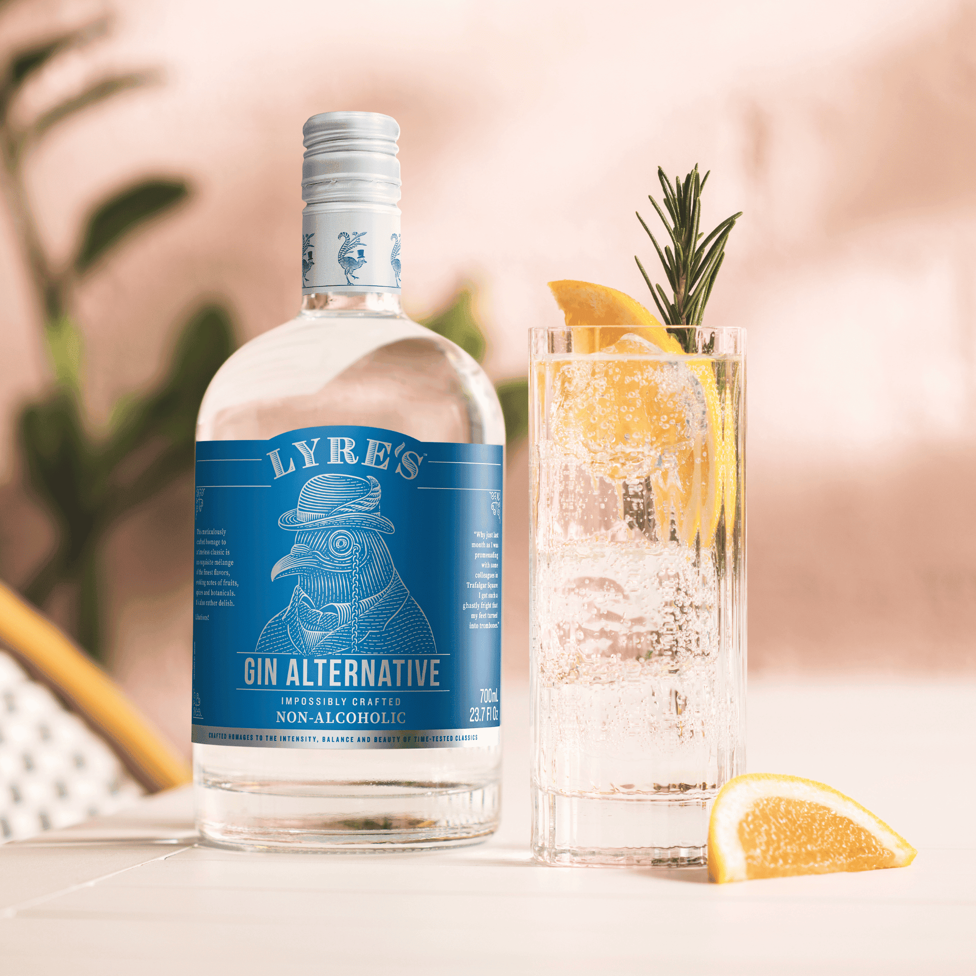 Lyre's Gin Alternative bottle with a non-alcoholic gin and tonic on a blurred background